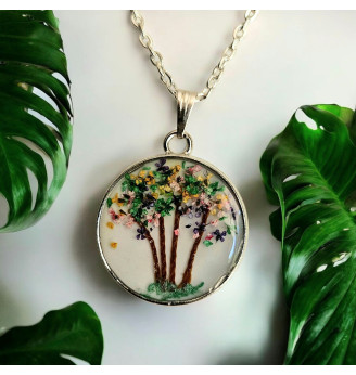 Pendentif en résine , poétique en fleurs séchées multicolores .